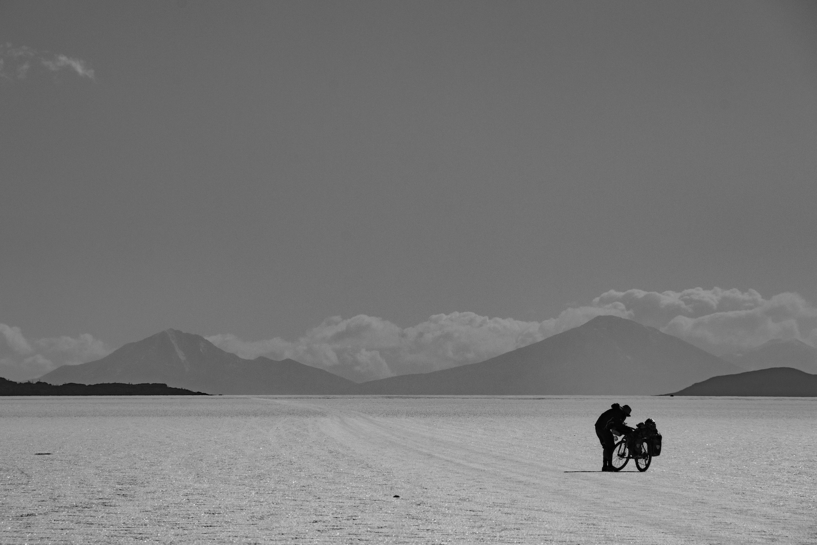 A cyclist on a salt pan